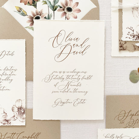 bespoke wedding invitation with brown ink and flowing script printed on off white cotton cardstock with handtorn edges