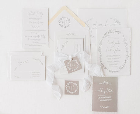 grey and white wedding invitation set with hand illustrated oval border, white silk ribbon, and grey details card