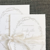 wedding invitation with minimal illustrated botanical border printed in grey ink or handtorn cotton cardstock with natural silk ribbon