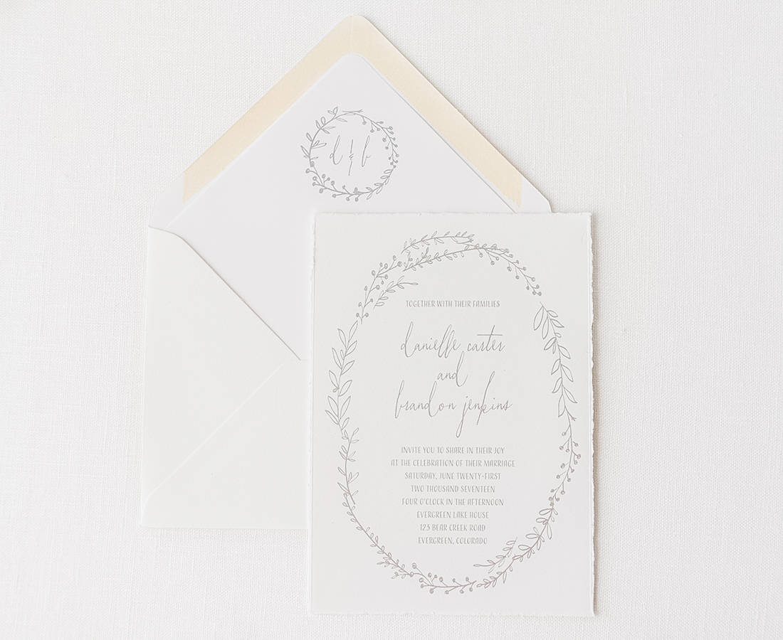 wedding invitation and envelope printed in grey on handtorn cotton cardstock with monogrammed envelope liner