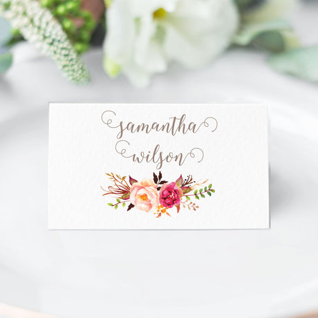 folded place card featuring calligraphy script font and watercolor pink blush floral bouquet