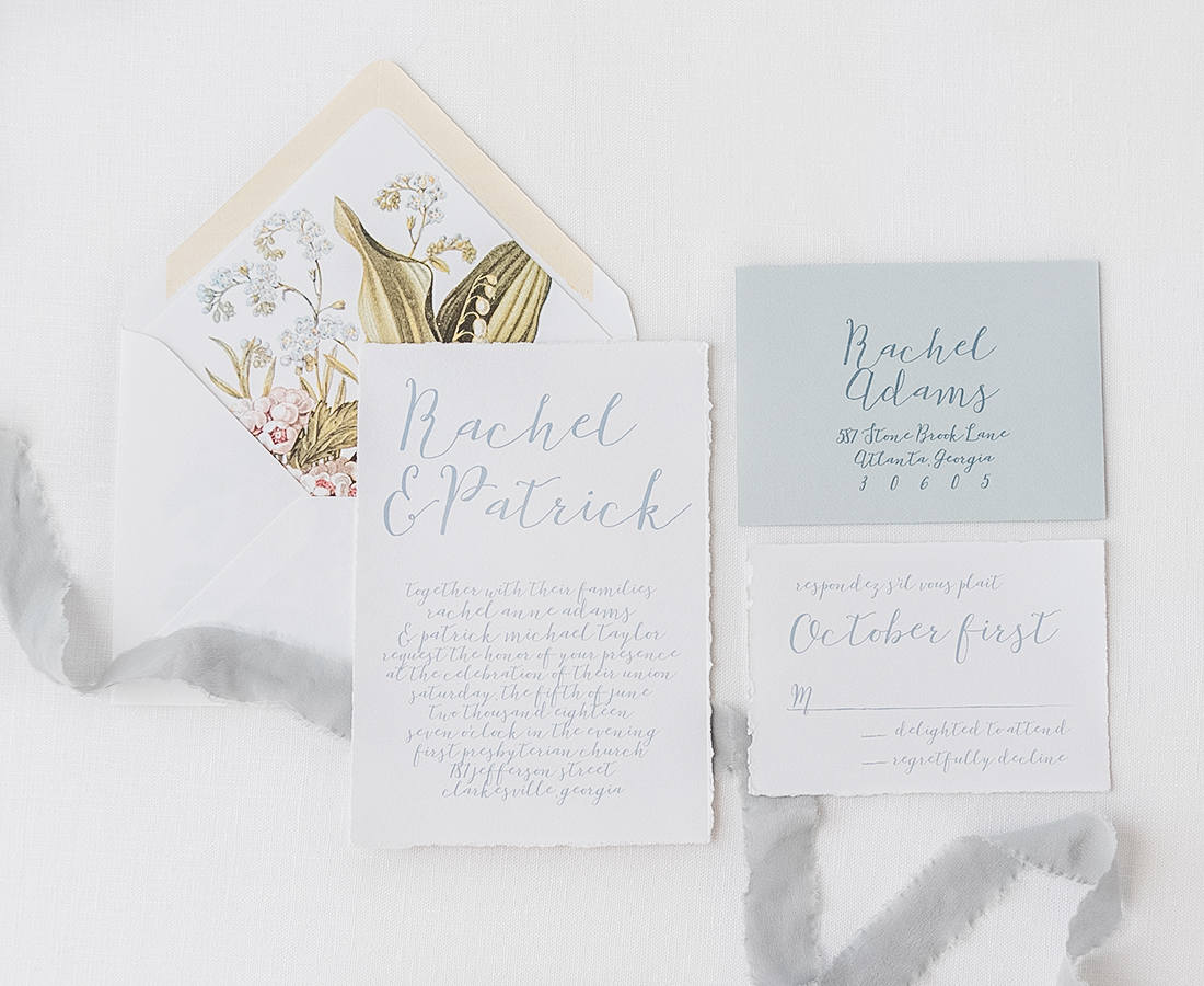 luxury wedding invitation with handtorn cardstock, dusty blue ink, evelope and antique painting envelope liner