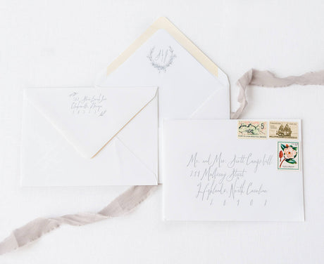 white envelopes with gray guest and return addressing and monogrammed envelope liner