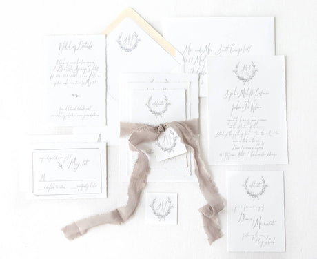 fine art wedding invitation set with handtorn edges, vintage crest and gray silk ribbon